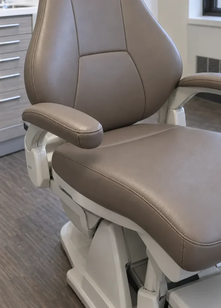 A dental patient chair seat recovered in taupe vinyl