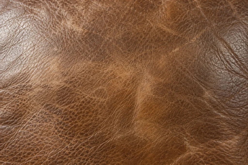 Detail of blotchy, faded recliner hide prior to work