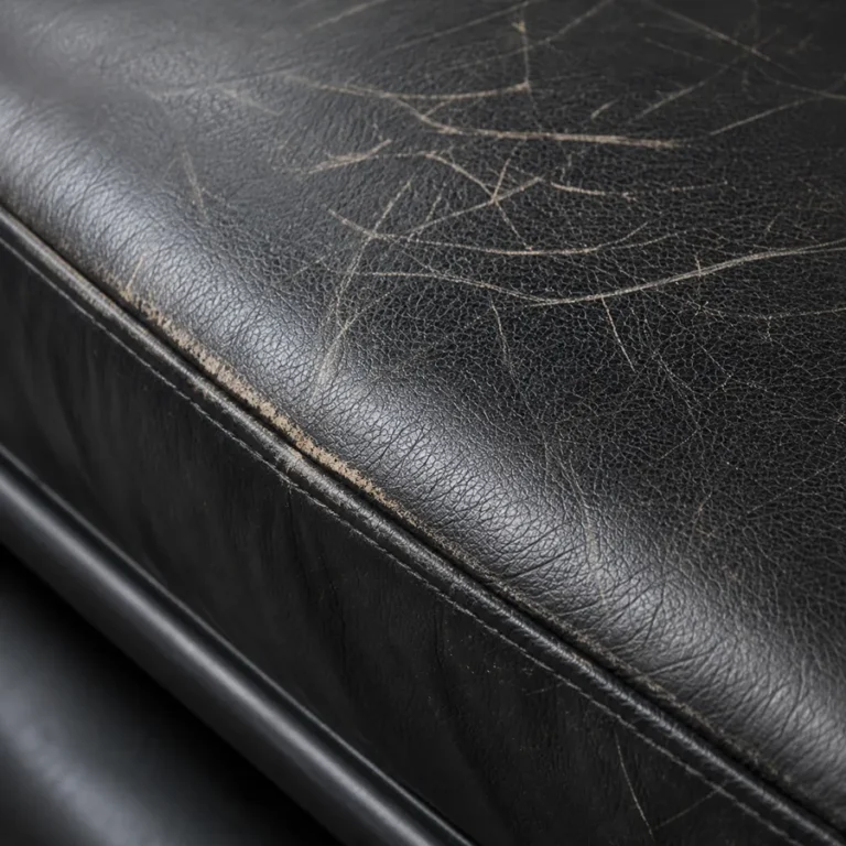 Fine cracks across a black leather seat in a bank office