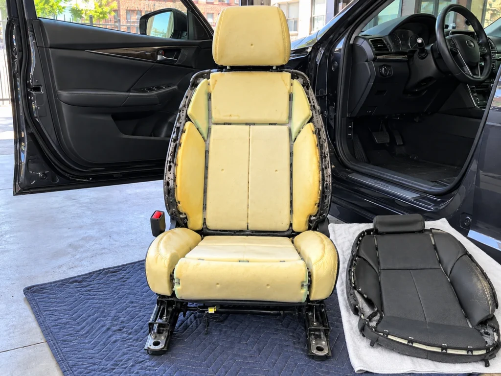 A driver's seat stripped to its foam and frame