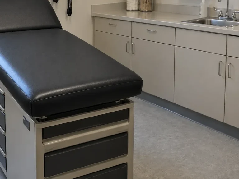 The same exam table recovered in black clinical vinyl