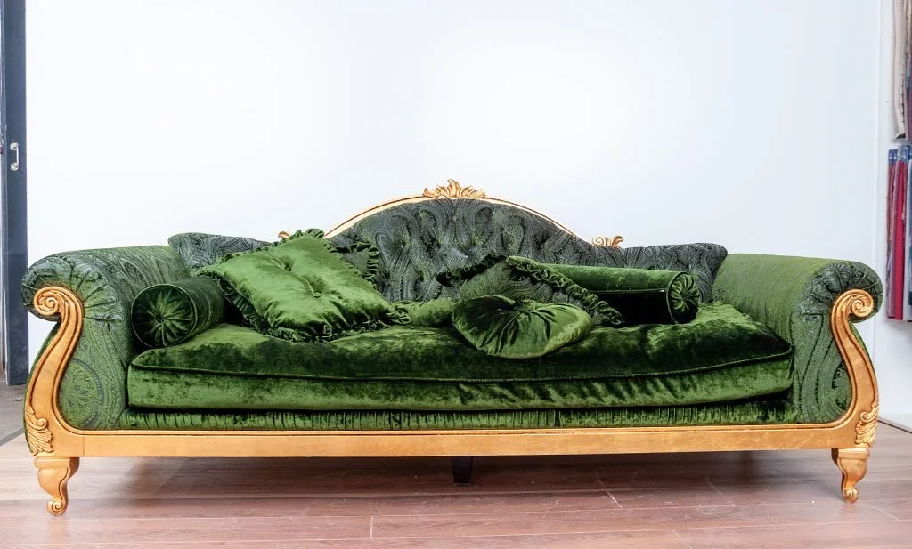 A gilded sofa with crushed green velvet before reupholstery