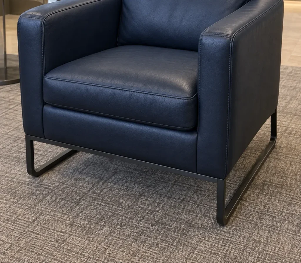 The same armchair recovered in navy leather