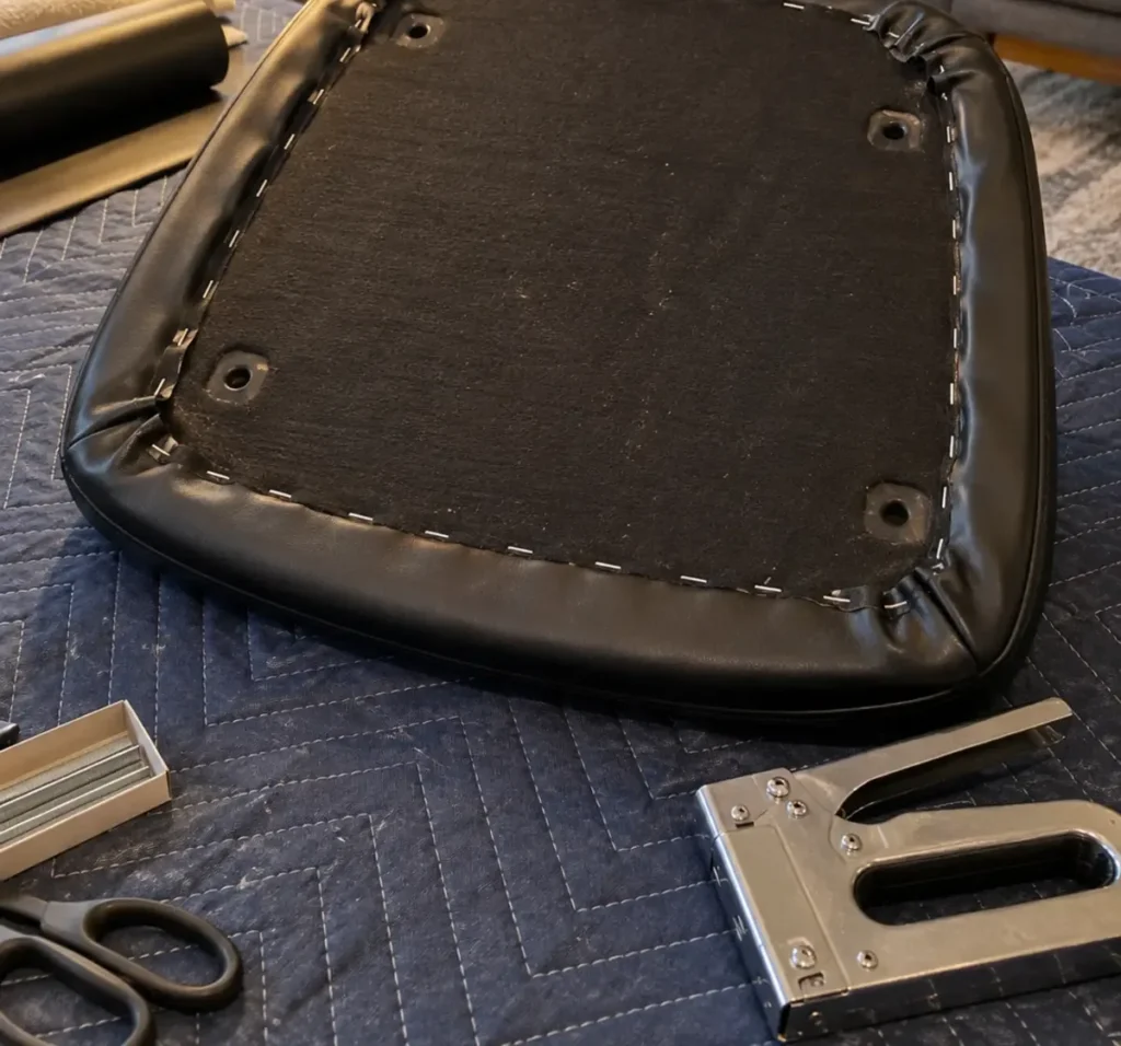 Seat pad with its new cover stapled on
