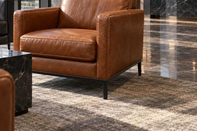 A lobby lounge chair with leather bleached by sunlight