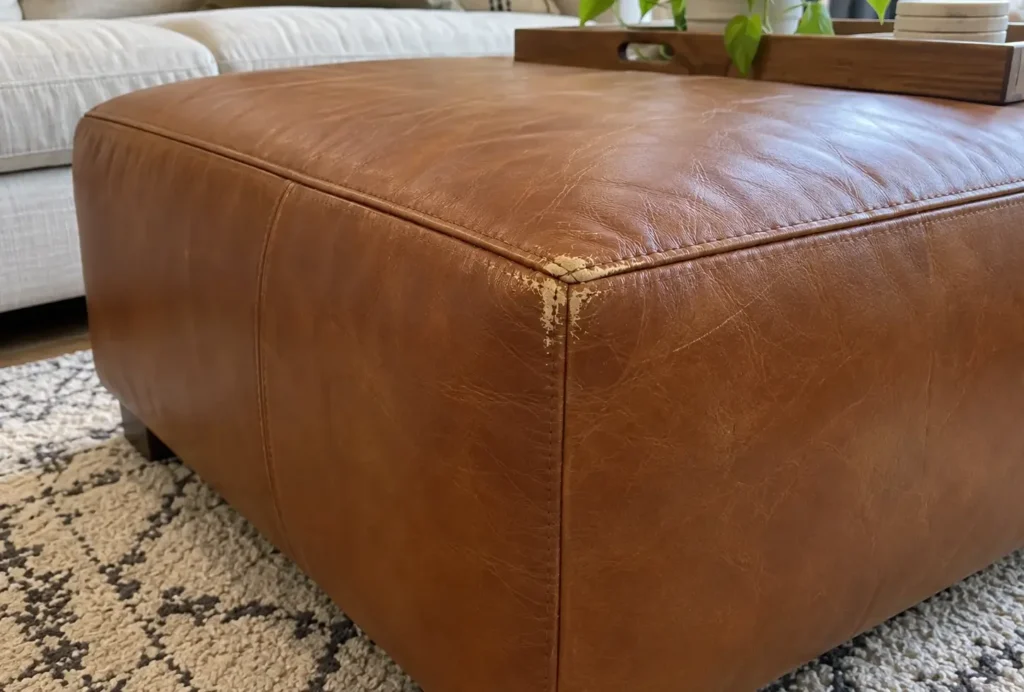 Scuffed corner on a leather ottoman