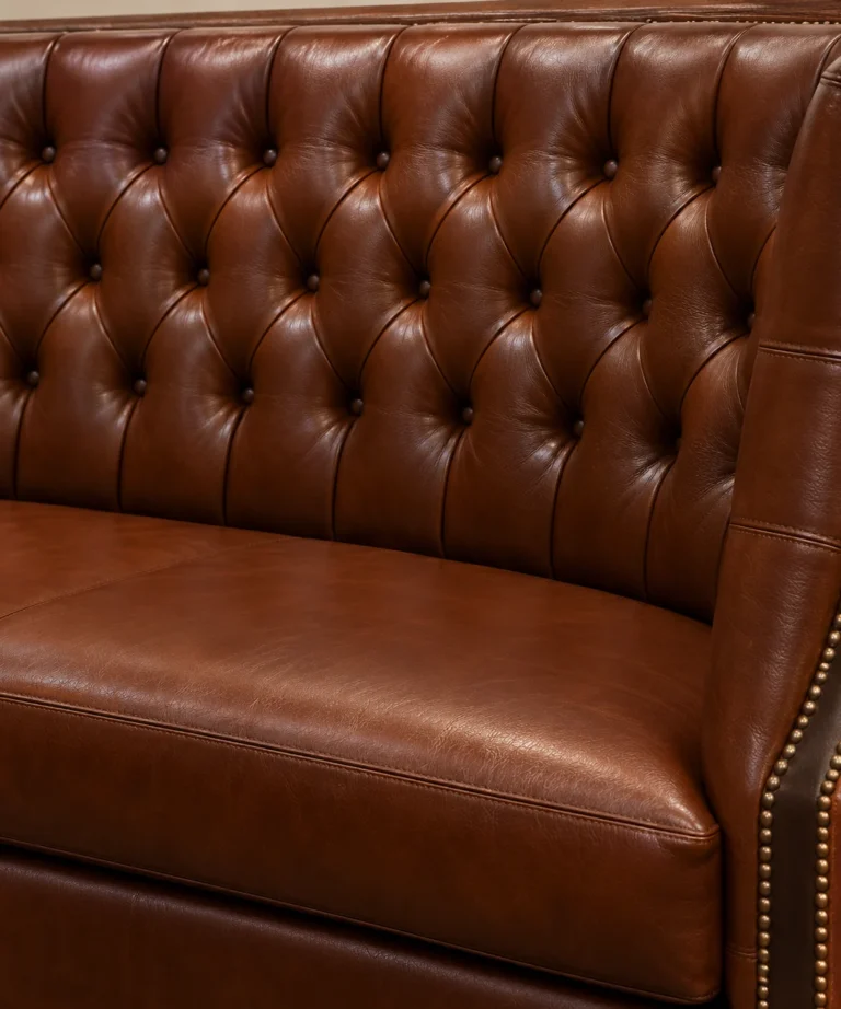 A recovered brown chesterfield with deep buttoning