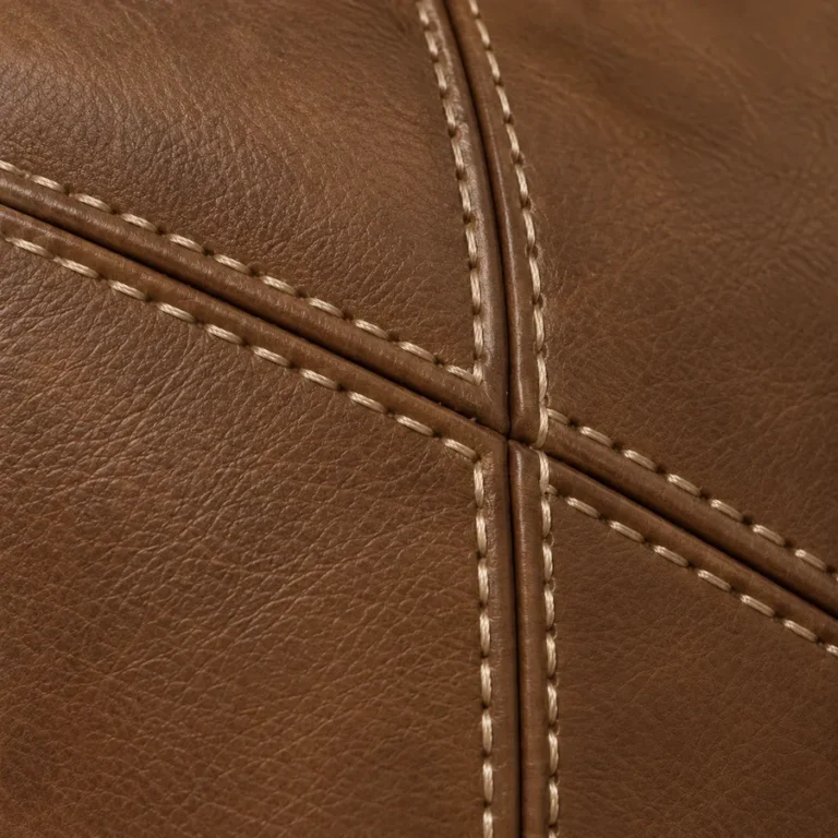 Close-up of contrast thread on a recovered leather sofa
