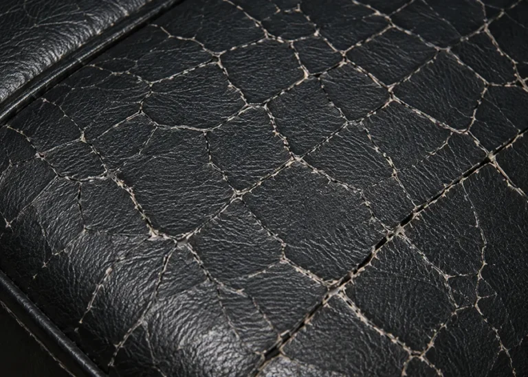 Black vinyl seat panel crazed with fine cracks