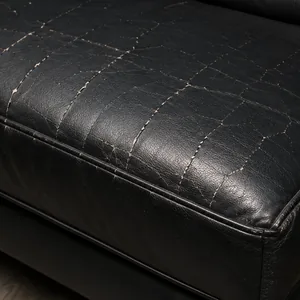 Cracks along the front edge of a black vinyl seat